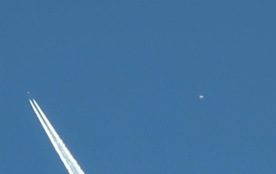 Still removed from video footage of UFO buzzing chemtrail jet