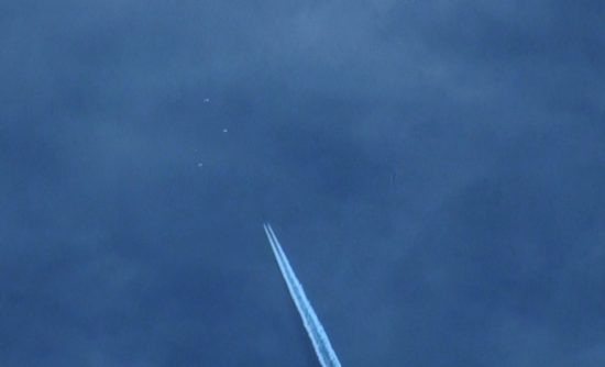 Multiple UFO's Buzzing Chemtrail Jet. July 10, 2012, Antelope Valley, Ca. Antelope Valley, Ca. Photo by Jim Kerr.