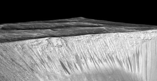 Dark narrow streaks called recurring slope lineae emanating out of the walls of Garni crater on Mars. The dark streaks here are up to few hundred meters in length. They are hypothesized to be formed by flow of briny liquid water on Mars. The image is produced by draping an orthorectified (RED) image (ESP_031059_1685) on a Digital Terrain Model (DTM) of the same site produced by High Resolution Imaging Science Experiment (University of Arizona). Vertical exaggeration is 1.5. Credits: NASA/JPL/University of Arizona