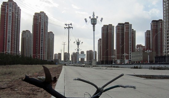 An empty street in front of a vacant residential complex in the city of Kangbashi, Ordos. The difference from last report in 2012 is that real estate prices in Kangbashi have plummeted since 2010 and continue to do so. Dozens of migrant workers rent vacant office spaces as apartments for as low as $65 a month.UNHEARD OF! 